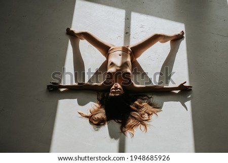 girl in panties with wide-spread legs on the floor