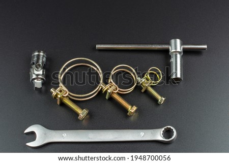 metal wire clamps and tools on black background