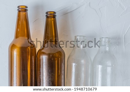 STELKED bottles on a light background, garbage sorting rules, dark bottle, light