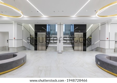 Interior photography, contemporary corridor hall business center in white tiles with Marble