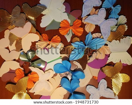 Multi-colored butterflies of different shapes made of paper. 