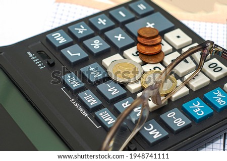 on the calculator are coins and points the concept of saving capital investment budget. High quality photo