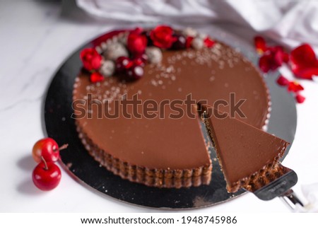 Chocolate tart with fruits in the top on white background 