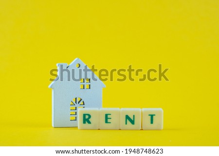 Plastic tiles with the text Rent with house model. 