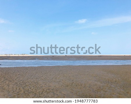 [Madagascar] Two African women walking on a sandy beach after the tide (Betania village, Morondava)