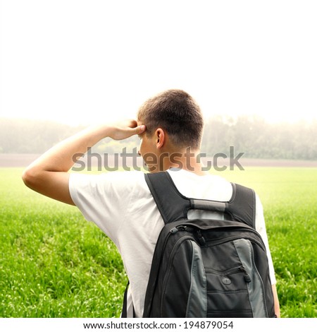 Toned photo of Teenager with Knapsack at the Summer Field