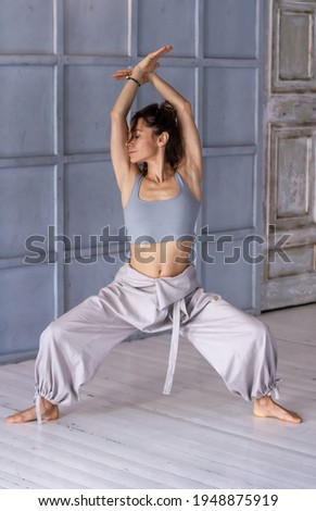 The girl demonstrates various poses from yoga