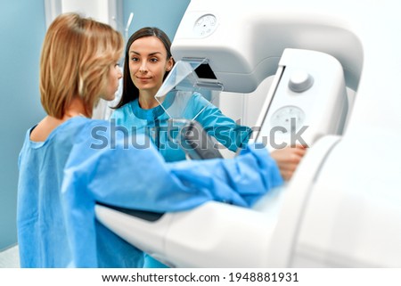 In the hospital, the patient undergoes a screening procedure for a mammogram, which is performed by a mammogram. A modern technologically advanced clinic with professional doctors. Royalty-Free Stock Photo #1948881931