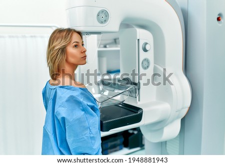 In the hospital, the patient undergoes a screening procedure for a mammogram, which is performed by a mammogram. A modern technologically advanced clinic with professional doctors. Royalty-Free Stock Photo #1948881943