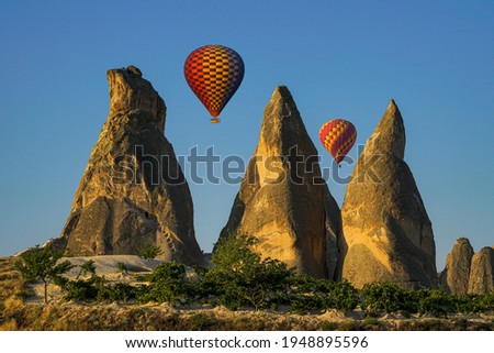 Fairy chimneys are a structure formed by rain, wind and flood waters eroding the structures made of tuffs. The shape of the fairy chimneys is conical. In addition, there is a rock block on its hills. Royalty-Free Stock Photo #1948895596