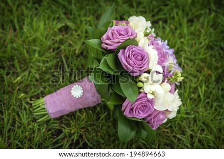 picture of a wedding bouquet , Wedding bouquet of pink and white roses lying on grass 