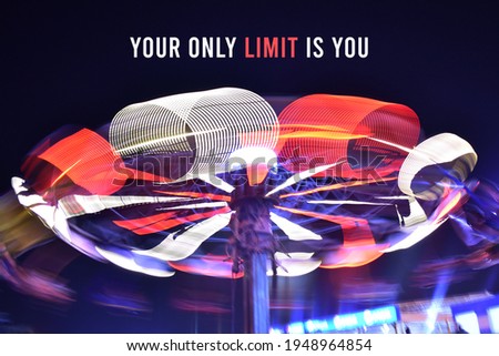 Inspirational, motivational quote 'your only limit is you' written on long exposure photograph of a fast moving ride. slow shutter speed orange and white light spirals.