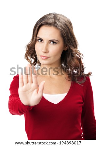 Serious young woman showing stop gesture, isolated over white background