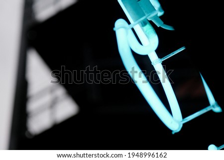 glowing fragment of a neon sign, close-up, abstract background