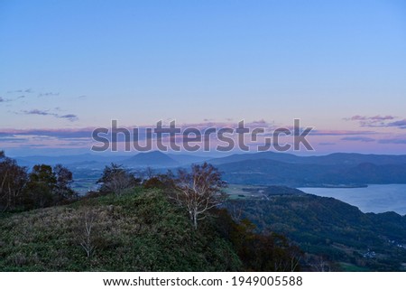 Scenery of Mt. Yotei and Lake Toya stained in the sunset at Hokkaido 