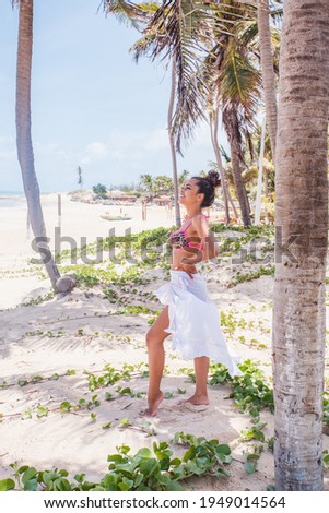beautiful afro woman on vacation at the beach. Afro woman extending hand for travel invitation