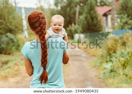mom hugs her daughter in nature
