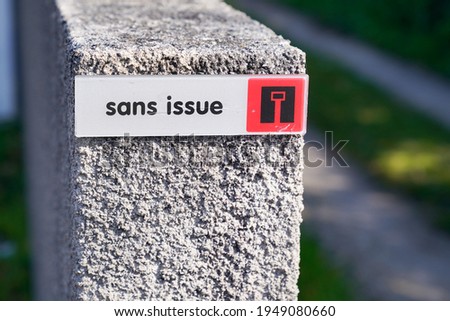 sans issue french text sign means No through road in street city