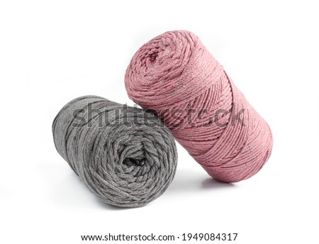 Grey and pink thread rolls for knitting isolated on white background. Macrame