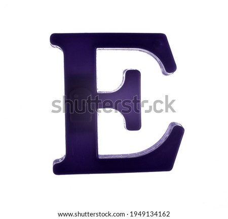 Plastic letter E on magnet isolated on white background, top view 