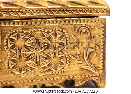 Isolated photo of a wooden box with folk-style wood carvings