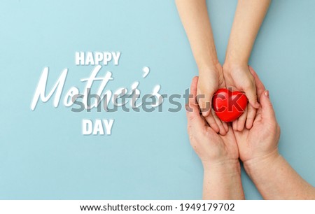 Concept Happy Mother's Day or International Day of Families.Happy women's day.Heart in the hands of daughter and mother on a blue background.I love you.Banner for store.Greeting card. Top view. Banner Royalty-Free Stock Photo #1949179702