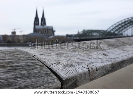 Wooden Handrail in Front of the Cathedral of Cologne anf a Bridge