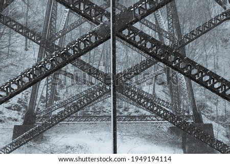 Symmetric closeup of the base of the Cap-Rouge 1908 railway trestle bridge covered in a light unseasonal spring snow fall, Quebec City, Quebec, Canada Royalty-Free Stock Photo #1949194114