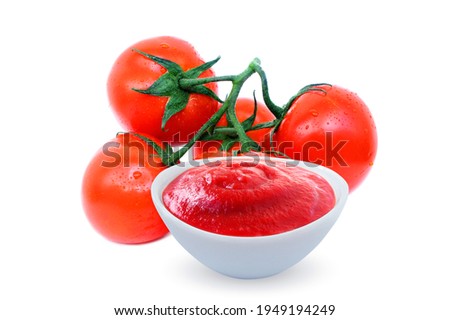 Fresh red tomatoes with water drops and ketchup in white bowl isolated on white background.
