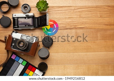 Photographer's desk made of wood with a camera and palettes. High quality photo
