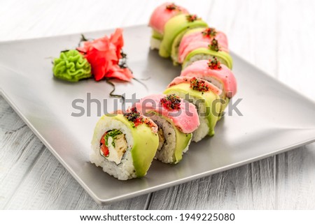 Dragon roll sushi, tuna, salmon, fish roe On wooden background