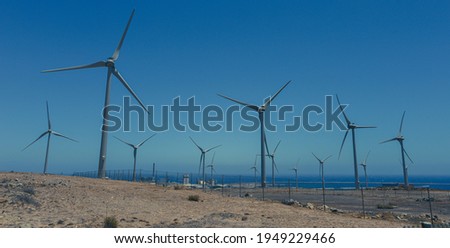 power wind turbines at sunset