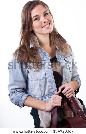 Close-up of a young woman holding her handbag
