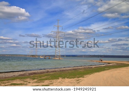 The photo was taken in Ukraine at the Telegulsky estuary. The photo shows the landscape of the estuary with the power transmission towers installed directly in the water.