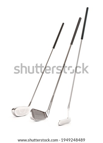Set of three golf clubs on white background