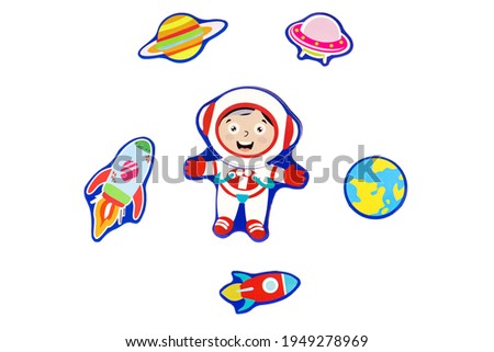 Cardboard figurines on a white background, isolated astronaut, planets and rockets