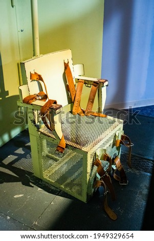 Lethal injection metal prison chair in the cell for death sentence Royalty-Free Stock Photo #1949329654