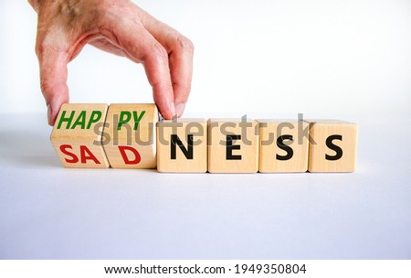 Happyness or sadness symbol. Businessman turns cubes and changes the word 'sadness' to 'happyness'. Beautiful white background. Business, psychological and happyness or sadness concept. Copy space.