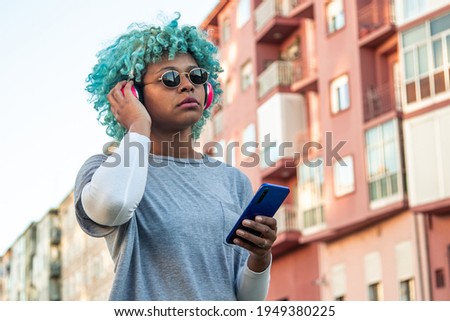 girl in the city listening to music with phone and headphones