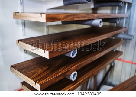 Furniture manufacture. The lacquered parts are dried on special shelves in the production hall. Close-up. Selective focus