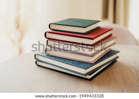 A notebook for teaching school records and events. Photo album for photos. Color modern books diaries in the office on the table. Copy space.