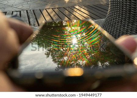 A colorful sunset reflection on the cellphone screen surface