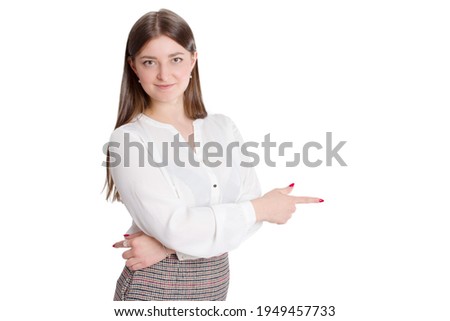 portrait of a young businesswoman in a white shirt and plaid skirt. pointing on a white isolated background with copy space.