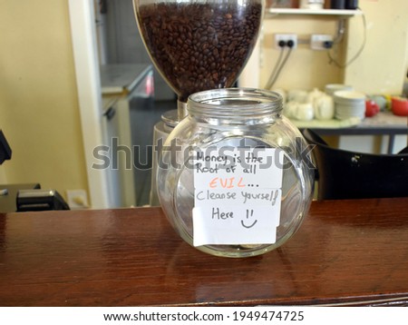 A jar suggesting you cleanse yourself by donating a tip in a coffee shop in Winton outback Queensland