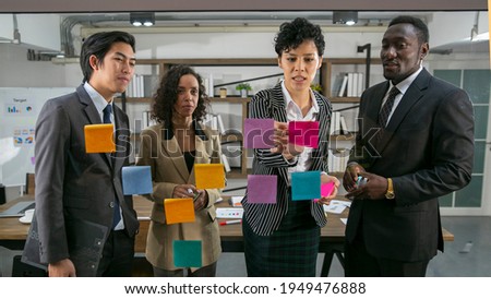 In multi business meeting, the middle east business woman posting her idea on the brainstroming board to share her thinking and point of view to define the root cause of failure analysis Royalty-Free Stock Photo #1949476888