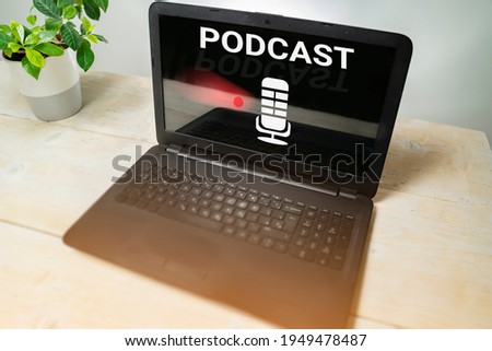 Podcast listening concept. Podcast on laptop, minimalistic setup