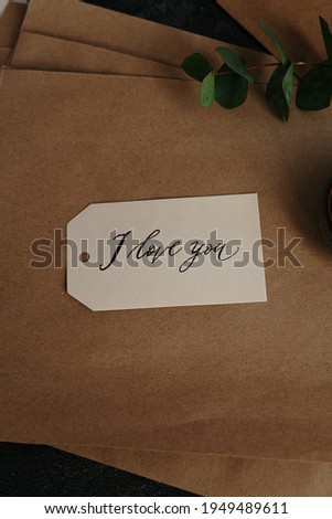 The tag of I love you on brown background so nice and look beautiful. In the background have tag have white and back side background have brown. The greenly have also used with them in the background.