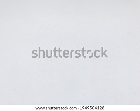 This is a background photo of a white cement wall with a few specks.