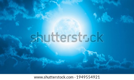 Night sky with blue full moon in the clouds "Elements of this image furnished by NASA"