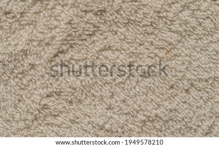 Texture of a floor cleaning cloth with a light brown color. Bright colored fabric that looks clean.